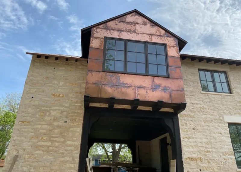Copper metal panel facade on a stone building for Metal Roof Coating in Maplewood