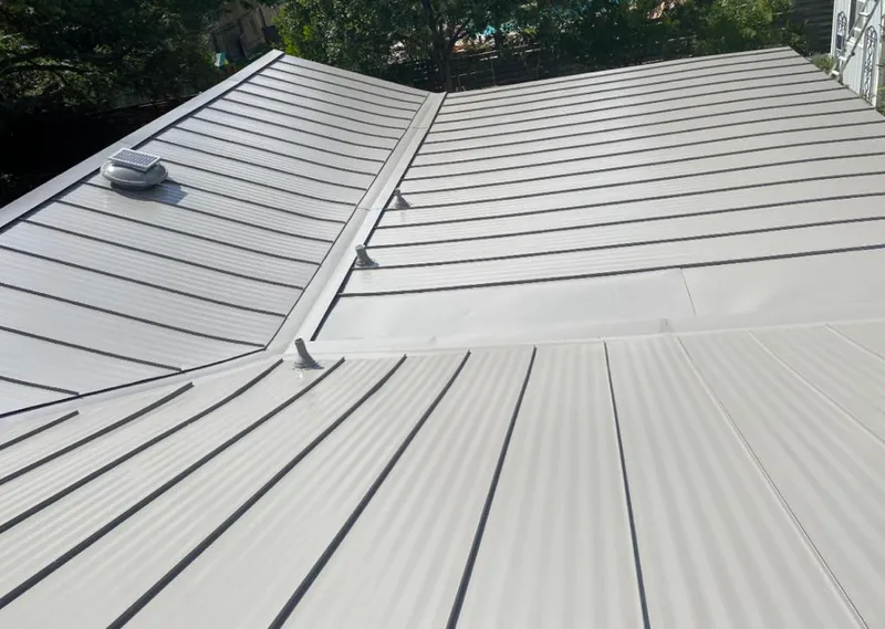 Solar attic fan installed on a metal roof for Roof Ventilation in Maplewood