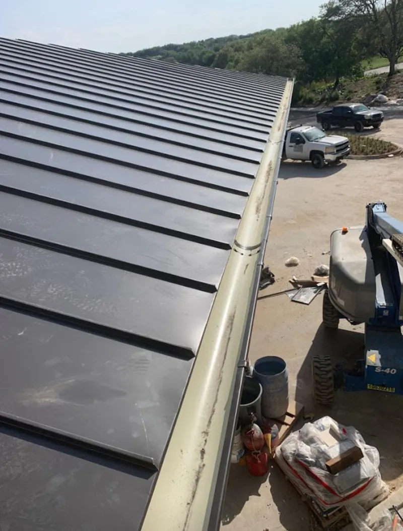 Standing seam panel and gutter detail on a metal roofing jobsite in Maplewood
